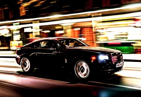 Rolls Royce Speeding Down The Road